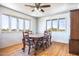 Dining room with hardwood floors, a ceiling fan, and a large window at 27141 E Javelina Dr, Florence, AZ 85132