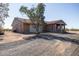 Exterior view of a single story home with a red tile roof, surrounded by a sparse desert landscape at 27141 E Javelina Dr, Florence, AZ 85132