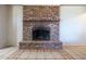 Close-up shot of brick fireplace featuring decorative tile and a protective screen at 27141 E Javelina Dr, Florence, AZ 85132