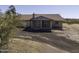 Front exterior view of a ranch-style home with a red tile roof surrounded by desert landscaping at 27141 E Javelina Dr, Florence, AZ 85132