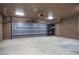 Attached two car garage with a roll up garage door and built-in storage shelves at 27141 E Javelina Dr, Florence, AZ 85132