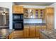 The kitchen features wood cabinets and modern black appliances at 27141 E Javelina Dr, Florence, AZ 85132