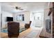 Bright living room showcasing a cozy layout with a fireplace and large windows at 27141 E Javelina Dr, Florence, AZ 85132