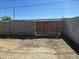 The backyard features a sturdy block wall and wooden gate at 2837 W Almeria Rd, Phoenix, AZ 85009