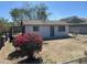 A single story home with a yard featuring a lush bougainvillea bush set against a clear blue sky at 2837 W Almeria Rd, Phoenix, AZ 85009