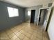 A bright bedroom with an adjacent bathroom, with tiled floor and closet at 2837 W Almeria Rd, Phoenix, AZ 85009