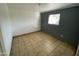 This bedroom boasts a tiled floor and a neutral two-tone color scheme at 2837 W Almeria Rd, Phoenix, AZ 85009