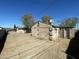 Back exterior of the house showing the yard and surrounding trees at 2837 W Almeria Rd, Phoenix, AZ 85009