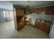 Functional kitchen with classic wood cabinets and neutral tile flooring at 2837 W Almeria Rd, Phoenix, AZ 85009