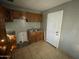 Functional kitchen features classic wood cabinets and neutral tile flooring at 2837 W Almeria Rd, Phoenix, AZ 85009