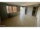 Inviting living room featuring tile flooring, freshly painted walls, and natural light at 2837 W Almeria Rd, Phoenix, AZ 85009