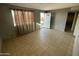 Inviting living room featuring tile flooring, freshly painted walls, and natural light at 2837 W Almeria Rd, Phoenix, AZ 85009