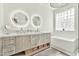 Modern bathroom featuring double sinks, quartz counters, glass shower, and separate tub at 2861 E Camellia Dr, Gilbert, AZ 85296