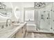 Modern bathroom featuring double sinks, quartz counters, glass shower, and separate tub at 2861 E Camellia Dr, Gilbert, AZ 85296