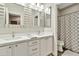 Bright bathroom with double vanity, quartz countertops, modern fixtures, and patterned shower curtain at 2861 E Camellia Dr, Gilbert, AZ 85296