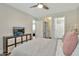 Bright bedroom with a ceiling fan, TV, and a view of the ensuite bathroom and laundry room at 2861 E Camellia Dr, Gilbert, AZ 85296