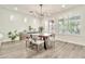 Bright dining area featuring stylish table setting, modern chandelier, and hardwood floors at 2861 E Camellia Dr, Gilbert, AZ 85296