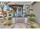 Inviting front porch with stylish blue door, decorative plants, and charming details at 2861 E Camellia Dr, Gilbert, AZ 85296