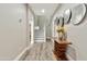 Hallway featuring a staircase, modern decor, hardwood floors, and access to the living spaces at 2861 E Camellia Dr, Gilbert, AZ 85296