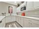 Bright kitchen area with white cabinets, quartz countertops, stainless steel appliances, and modern decor at 2861 E Camellia Dr, Gilbert, AZ 85296