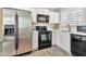 Bright kitchen featuring stainless steel refrigerator, black appliances, and white cabinets for a modern aesthetic at 2861 E Camellia Dr, Gilbert, AZ 85296