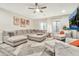 Bright living room with a sectional sofa, plush rug, modern decor, and window views at 2861 E Camellia Dr, Gilbert, AZ 85296