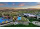 Expansive aerial view of community pool and recreation area with a lush golf course and mountain views at 28714 N Verde River Way, Rio Verde, AZ 85263