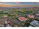 Breathtaking sunset aerial view of a home near a lush golf course in a vibrant community at 28714 N Verde River Way, Rio Verde, AZ 85263