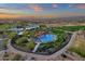 Beautiful aerial shot of a community pool area featuring sunshades, lounge chairs and scenic sunset views at 28714 N Verde River Way, Rio Verde, AZ 85263