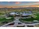 Stunning aerial view of community center with well-maintained lawns, palm trees, and desert mountain backdrop at 28714 N Verde River Way, Rio Verde, AZ 85263