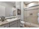 Bathroom with stone countertops, a tiled shower, and a framed mirror above the sink at 28714 N Verde River Way, Rio Verde, AZ 85263