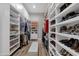 Large walk-in closet with custom white shelving and cabinets for maximum storage solutions at 28714 N Verde River Way, Rio Verde, AZ 85263