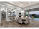 Elegant dining area with a modern chandelier, a sliding glass door, and backyard views at 28714 N Verde River Way, Rio Verde, AZ 85263