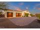 This is a stunning view of the front exterior, showcasing the home's three-car garage and beautiful landscaping at 28714 N Verde River Way, Rio Verde, AZ 85263