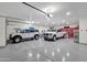 Spacious and organized garage featuring two cars, with bright lighting and a sealed floor at 28714 N Verde River Way, Rio Verde, AZ 85263