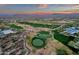 Scenic aerial view of golf course greens in a desert landscape with distant mountain views at 28714 N Verde River Way, Rio Verde, AZ 85263