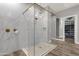 Modern glass shower with marble tile, gold fixtures, and a decorative honeycomb shower floor at 28714 N Verde River Way, Rio Verde, AZ 85263