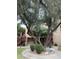 Exterior view of a tan building with wooden stairs and a lush tree in front at 3131 W Cochise Dr # 157, Phoenix, AZ 85051