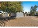 Exterior shot of the backyard featuring desert landscaping, a covered patio, and privacy fence at 3223 W Purdue Ave, Phoenix, AZ 85051