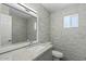 Well-lit bathroom featuring a large mirror and tile walls at 3223 W Purdue Ave, Phoenix, AZ 85051