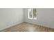 Bedroom featuring hardwood flooring, white walls, and a window at 3223 W Purdue Ave, Phoenix, AZ 85051