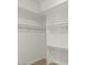 Walk-in closet with white shelving and wooden floor at 3223 W Purdue Ave, Phoenix, AZ 85051