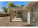 Charming covered patio features stone columns and provides access to the backyard with its low-maintenance desert landscape at 3223 W Purdue Ave, Phoenix, AZ 85051