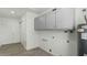 Laundry room with cabinets, water heater and access to outside at 3223 W Purdue Ave, Phoenix, AZ 85051