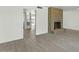 Bright living area with a brick fireplace and wood-look tile flooring at 3223 W Purdue Ave, Phoenix, AZ 85051