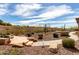 Beautiful backyard with desert landscaping and stone patio seating area at 42429 N Cross Timbers Ct, Anthem, AZ 85086