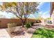 Landscaped backyard with brick walkway and mature trees at 42429 N Cross Timbers Ct, Anthem, AZ 85086