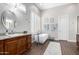 Light and airy bathroom featuring a modern soaking tub and wood grain vanity at 42429 N Cross Timbers Ct, Anthem, AZ 85086