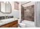 Bathroom featuring tub and shower with decorative window treatment and wood vanity at 42429 N Cross Timbers Ct, Anthem, AZ 85086