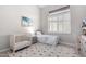 Cozy bedroom with a crib and single bed, featuring soft colors and plantation shutters at 42429 N Cross Timbers Ct, Anthem, AZ 85086